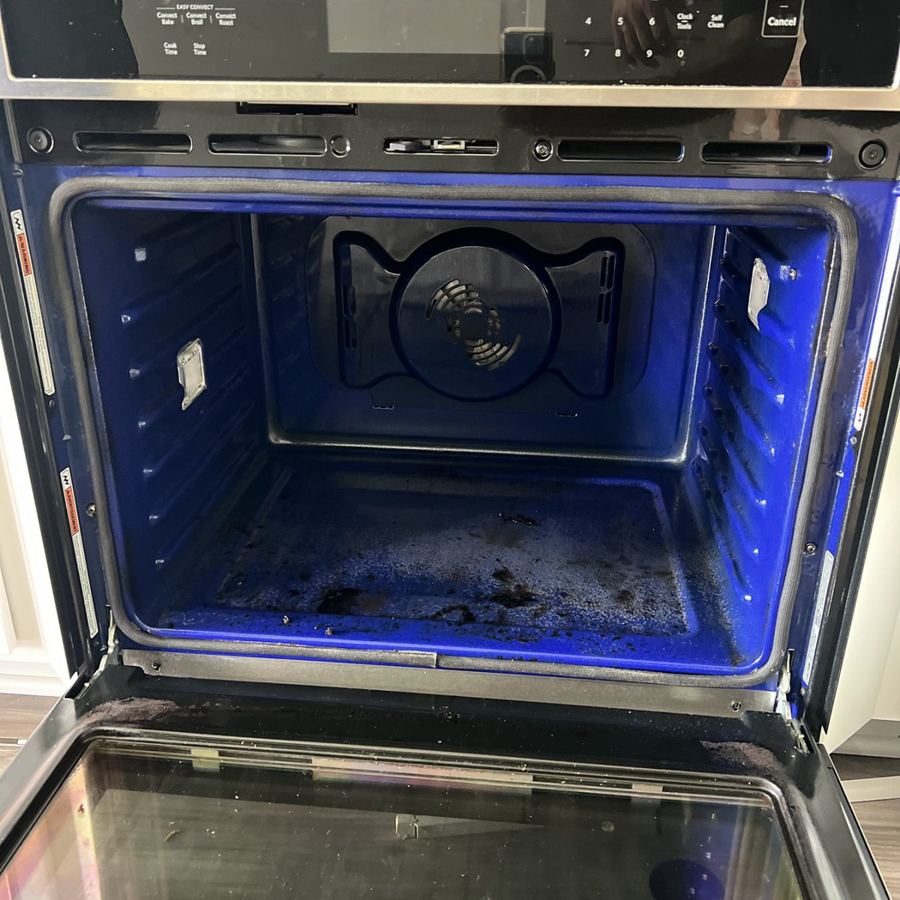 Oven interior with burnt-on food and grease before cleaning