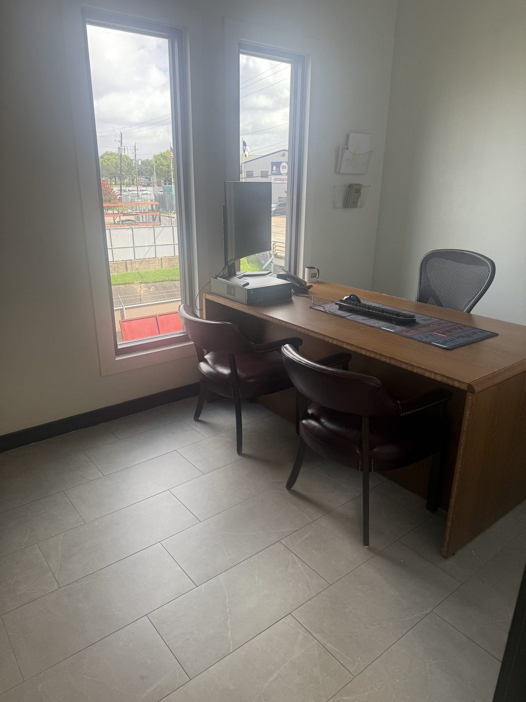 Private office in a tenant suite with desk, chairs and tile floor after cleaning